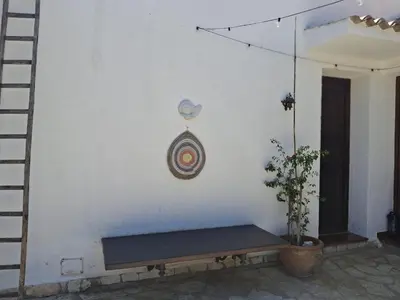 a wall with a bench against a wall with a dart at The Green Planet in Balestrate