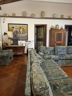 a living room with couches and a table at The Green Planet in Balestrate