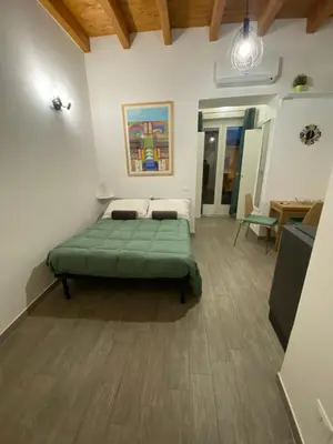 a bedroom with a green bed in a room at White House Theater Massimo in Palermo