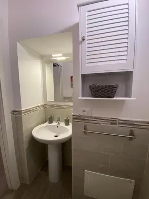 a bathroom with a sink and a mirror at White House Theater Massimo in Palermo