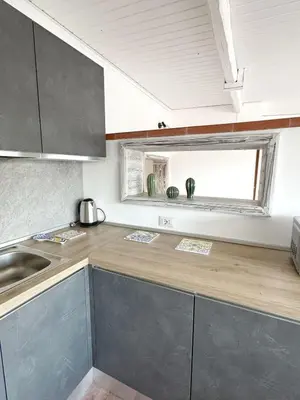 a kitchen with a counter and a sink and a window at Casa Ragonese in Palermo