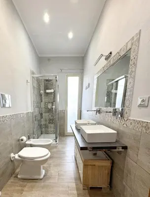 a bathroom with two sinks and a toilet and a shower at Casa Ragonese in Palermo
