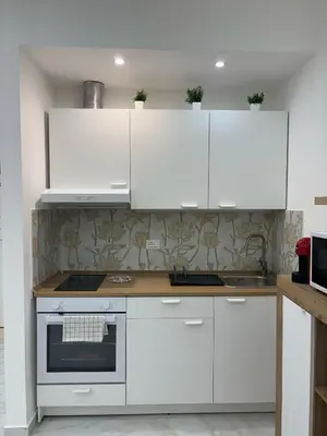 a kitchen with white cabinets and a stove at A Casa di Giro suite apartment in Palermo