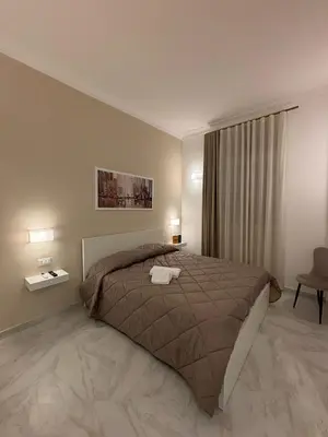 a bedroom with a large bed and a window at A Casa di Giro suite apartment in Palermo