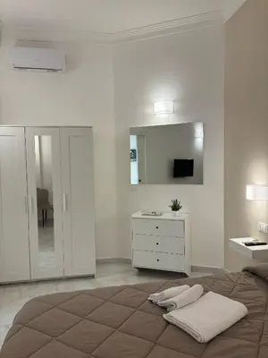 a bedroom with a bed and a dresser and a mirror at A Casa di Giro suite apartment in Palermo