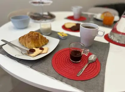a table with a plate of food and a cup of coffee at Casa Bontà in Palermo