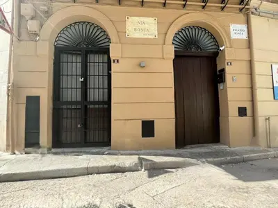 a building with two brown doors with a sign on it at Casa Bontà in Palermo