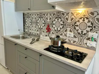 a kitchen with a stove with a pot on it at Casa Bontà in Palermo
