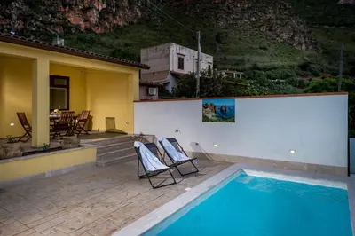 a view of a swimming pool at night at Villa Paradise Luxury in Castellammare del Golfo