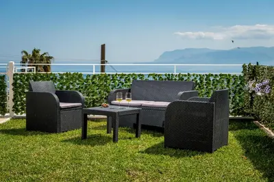 a straw hat and sunglasses sitting next to a swimming pool at Villa Paradise Luxury in Castellammare del Golfo