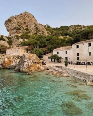 a backyard with a swimming pool and chairs and a house at Villa Paradise Luxury in Castellammare del Golfo