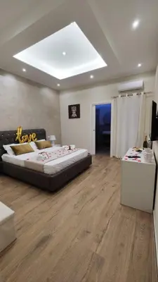 a large bedroom with a large bed and a table at INFINITY Luxury Apartment in Palermo