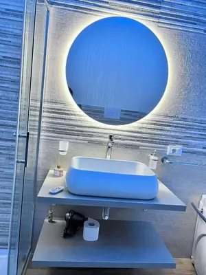 a bathroom with a sink and a large mirror at INFINITY Luxury Apartment in Palermo