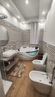 a bathroom with two toilets and a tub and a sink at INFINITY Luxury Apartment in Palermo