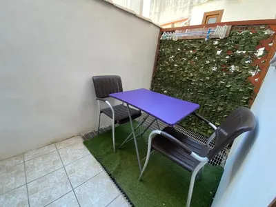 a purple table and chairs on a balcony at Le Ortensie Appartamento Grande in San Vito lo Capo