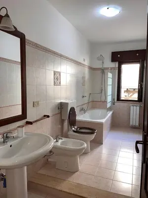 a bathroom with a shower and a toilet and a sink at A Casa Da Mari' in Terrasini