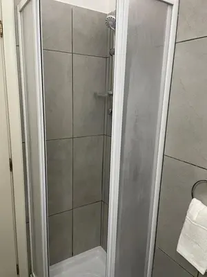 a shower with a glass door in a bathroom at Appartamento Ciccio al Capo in Palermo