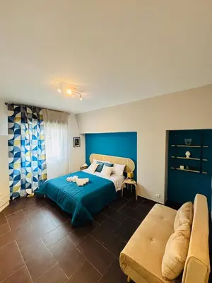 a bedroom with a bed and a couch at Maison N 16 in Palermo