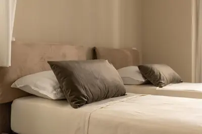 two beds with pillows on them in a room at Le Case del Massimo in centrocittà in Palermo