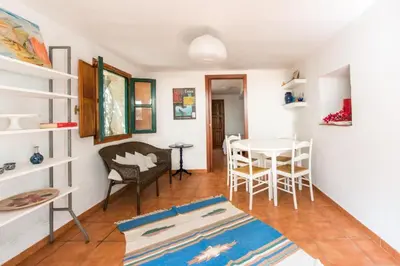 a living room with a table and chairs at Villa Emma 50 mt from the sea with private pool in Carini