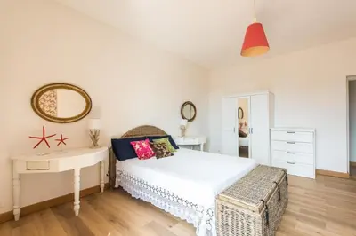 a bedroom with a bed and a desk and a mirror at Villa Emma 50 mt from the sea with private pool in Carini