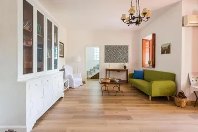 a living room with a green couch and a table at Villa Emma 50 mt from the sea with private pool in Carini