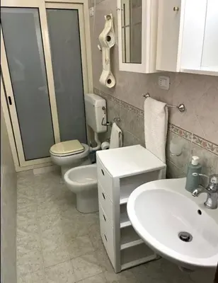 a bathroom with a toilet and a sink and a toilet istg at La rosa dei venti in Isola delle Femmine