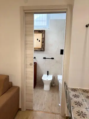 a bathroom with a toilet and a sink at Palermo Sunset in Palermo