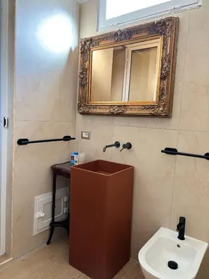a bathroom with a sink and a mirror and a toilet at Palermo Sunset in Palermo