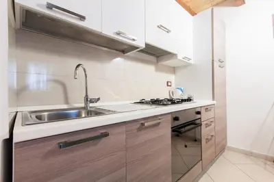 a kitchen with a sink and a stove at Casa vacanze Giusi in Castellammare del Golfo
