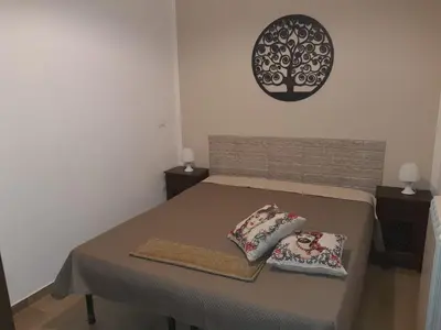 a room with a bed with two pillows on it at Casa Vacanza Isola di Eufemio Piano Terra in Capaci