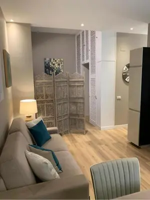 a living room with a couch and a chair at Sperlinga Suite in Palermo