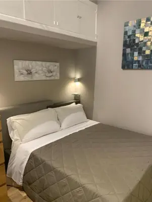a bedroom with a large bed with white pillows at Sperlinga Suite in Palermo