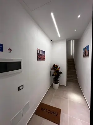a hallway with a staircase and a potted plant at La Casetta di Sa Lu in Capaci