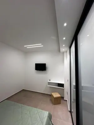 a white room with a tv on a wall at La Casetta di Sa Lu in Capaci