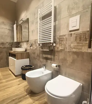 a bedroom with a bed with two towels on it at Borgese Apartments in Palermo