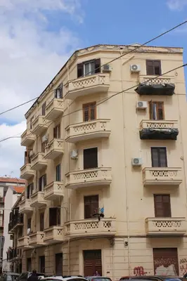 a bedroom with a bed with a large window at Borgese Apartments in Palermo