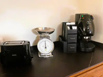 a clock sitting on a counter next to a coffee maker at Gira e Firria in Palermo