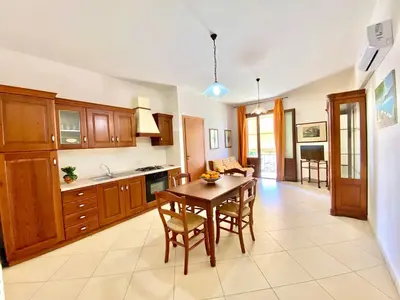 a bedroom with a white bed and a large window at Residence Piana, San Vito Lo Capo in San Vito lo Capo
