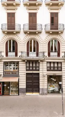a tall building with balconies and doors on it at G Cave 125 Boutique Apartment in Palermo