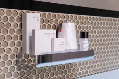 a shelf with some products on it on a wall at G Cave 125 Boutique Apartment in Palermo