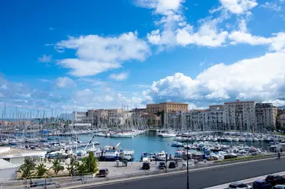 a marina with boats in the water and buildings at Vela House charming front of sea in Palermo