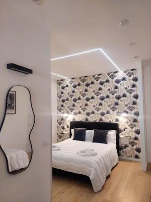 a bedroom with a bed and a mirror at Da Vera Apartment in Palermo