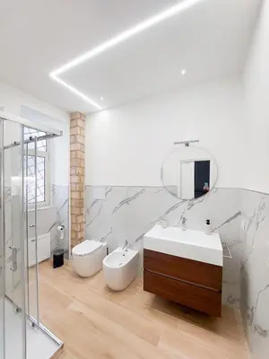 a bathroom with a sink and a toilet and a mirror at Da Vera Apartment in Palermo