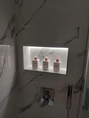 a bathroom with three soap bottles on a shelf at Da Vera Apartment in Palermo