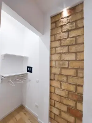 a brick wall in the corner of a room with white walls at Da Vera Apartment in Palermo