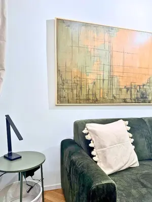 a living room with a green couch and a table at Plaza Suite in Palermo