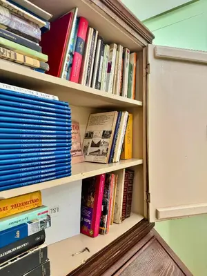 a book shelf full of books in a room at Plaza Suite in Palermo