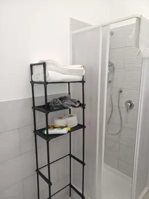 a black towel rack in a bathroom with a shower at La casa di gabry in Palermo