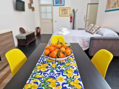 a table with a bowl of fruit on top of it at Cattedrale - Maiolica Brugnò in Palermo